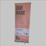 Roller banner with information about We Create Better.