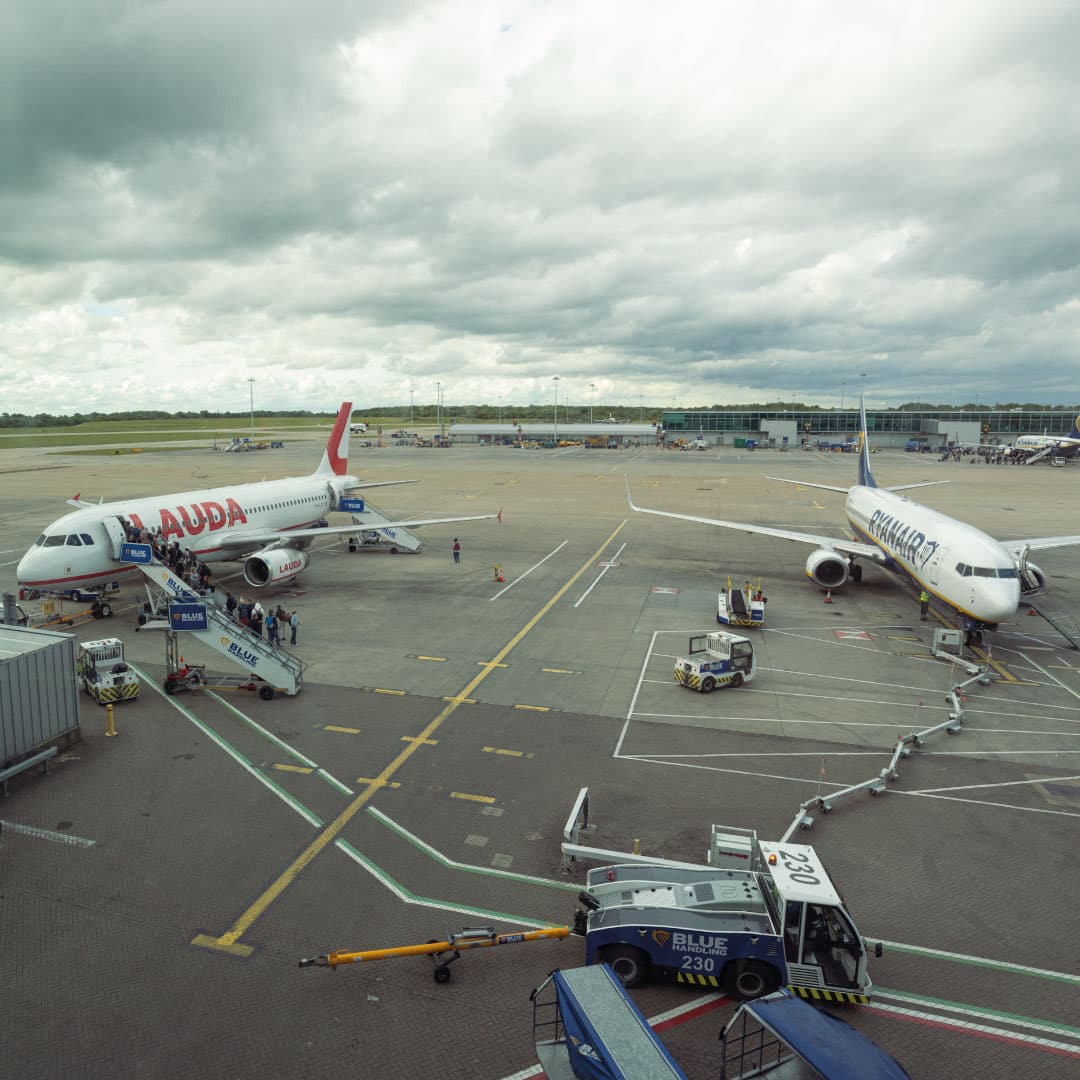 Lauda and Ryanair planes being boarded at London Stansted Airport.